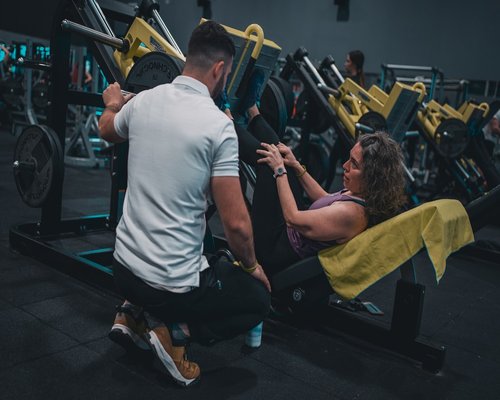 Senior couple doing fitness exercises in gym together